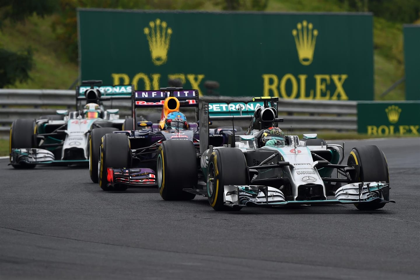 Nico Rosberg (GER) Mercedes AMG F1 W05 leads Sebastian Vettel (GER) Red Bull Racing RB10 and Lewis Hamilton (GBR) Mercedes AMG F1 W05. Formula One World Championship, Rd11, Hungarian Grand Prix, Race Day, Hungaroring, Hungary. Sunday, 27 July 2014. © Sutton Images