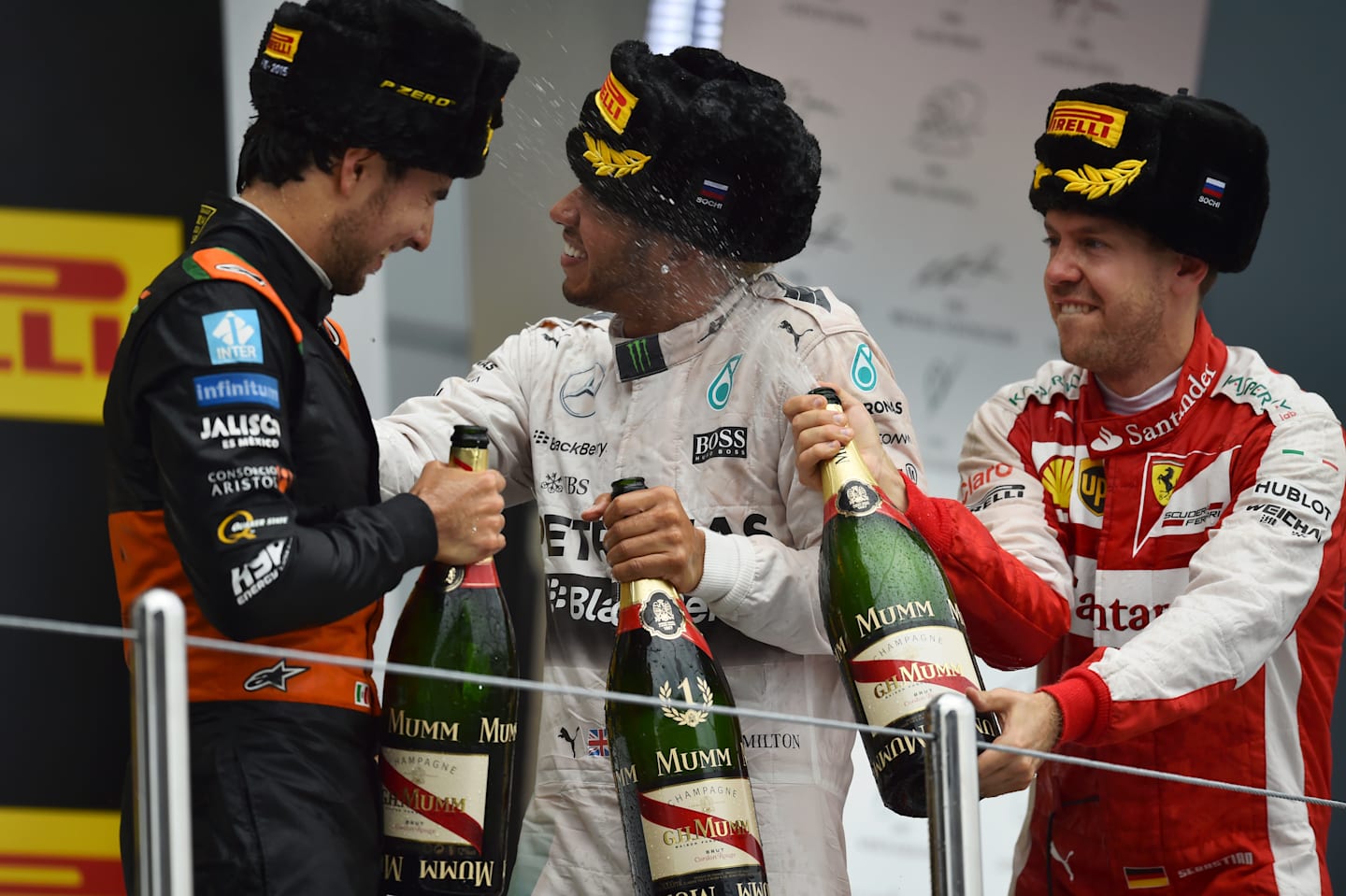 Sergio Perez (MEX) Force India, race winner Lewis Hamilton (GBR) Mercedes AMG F1 and Sebastian Vettel (GER) Ferrari celebrate on the podium with he champagne at Formula One World Championship, Rd15, Russian Grand Prix, Race, Sochi Autodrom, Sochi, Krasnodar Krai, Russia, Sunday 11 October 2015. © Sutton Motorsport Images