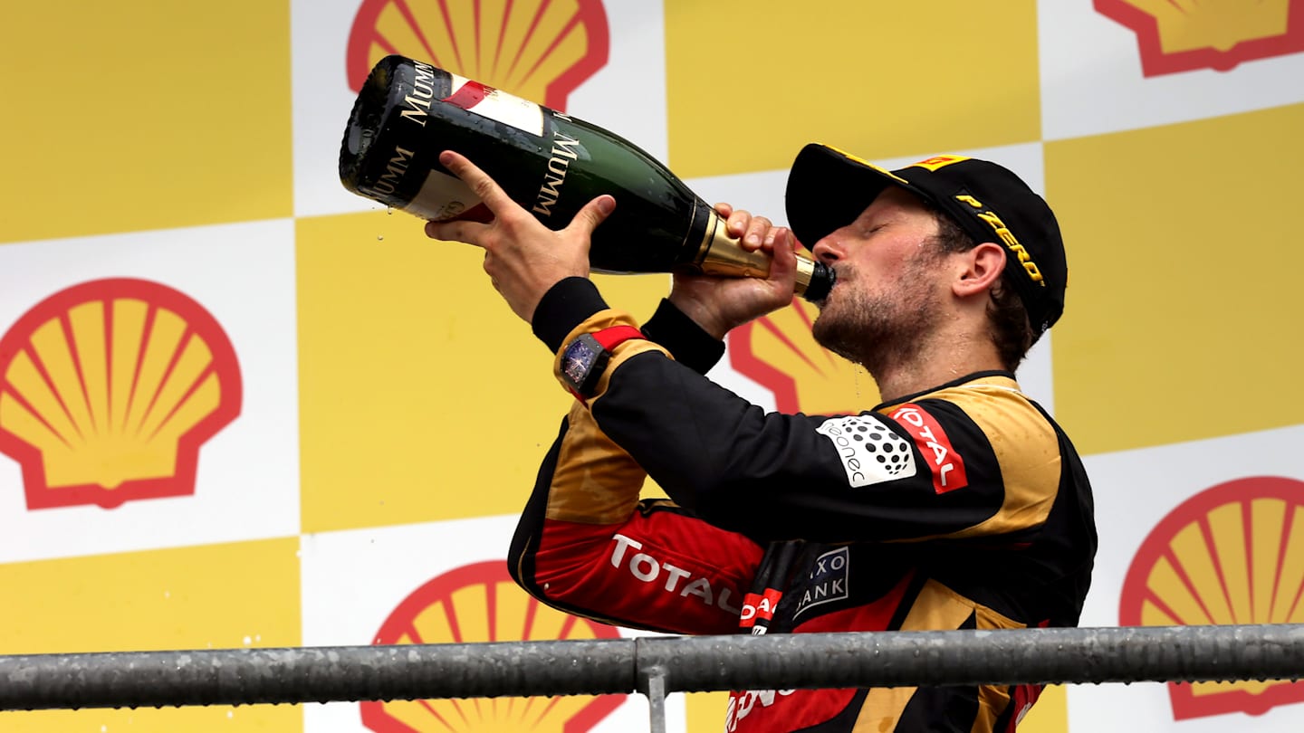 Romain Grosjean (FRA) Lotus F1 celebrates with the champagne on the podium at Formula One World