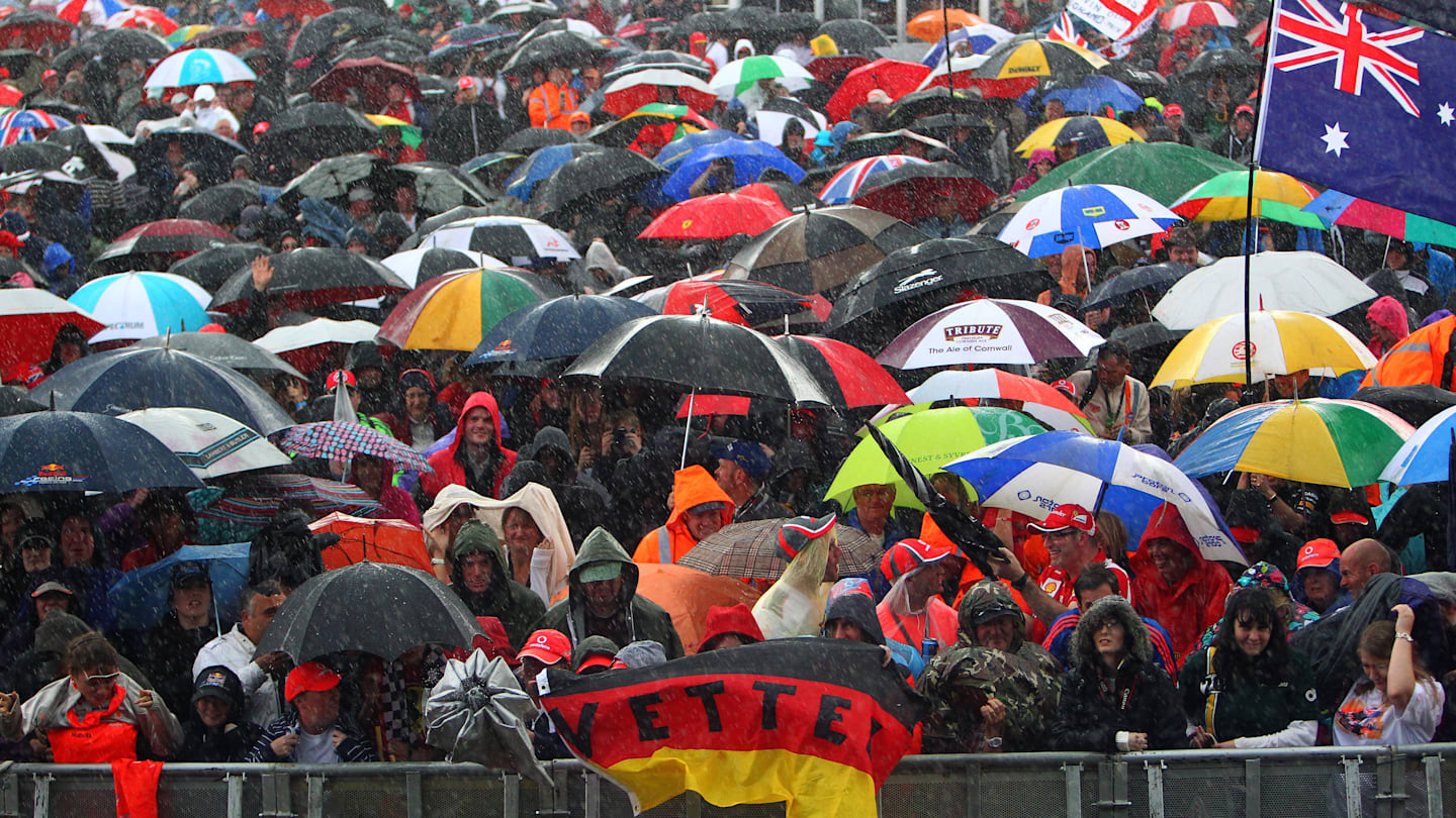 Fans brave the rain at the Grand Prix Party. Formula One World Championship, Rd9, British Grand