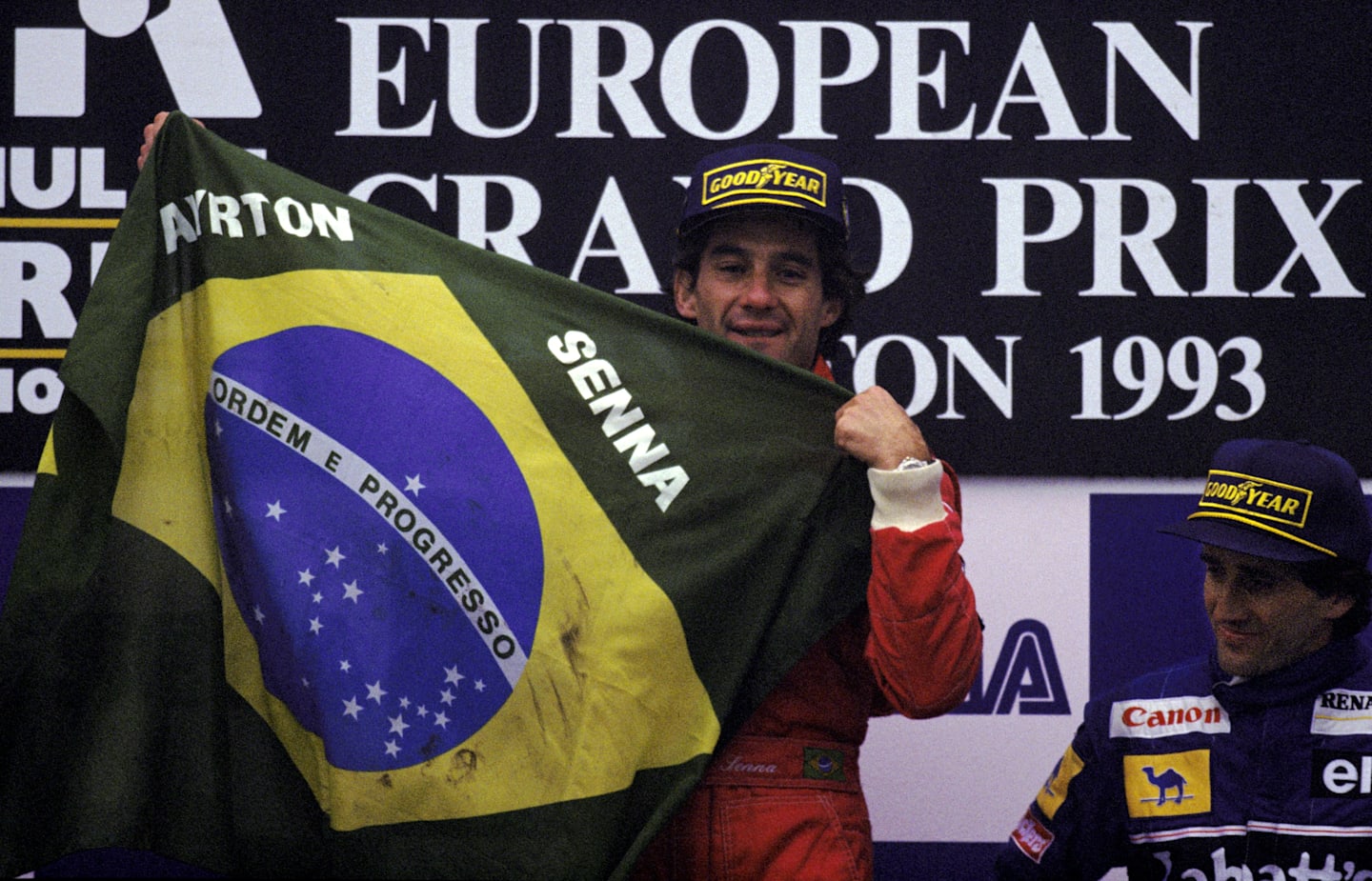 The podium (L to R): Ayrton Senna (BRA) McLaren celebrates a sensational victory with the Brazilian