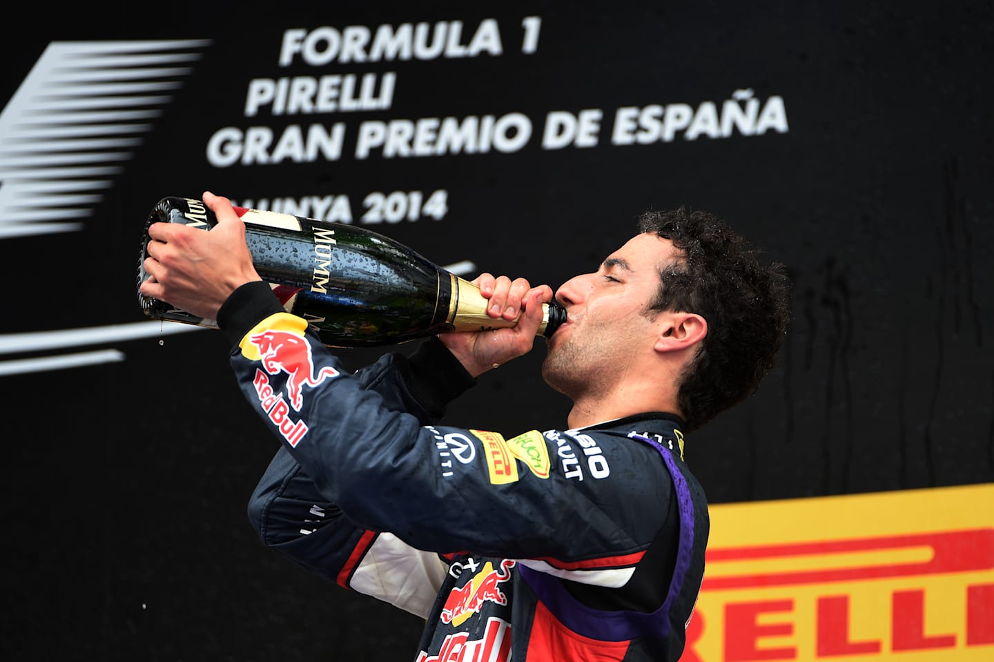 Daniel Ricciardo (AUS) Red Bull Racing RB10 celebrates on the podium with the champagne. Formula