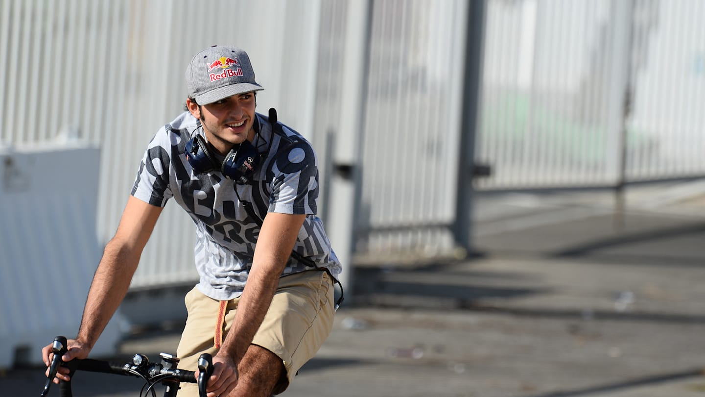 www.sutton-images.com  Carlos Sainz Jr (ESP) Red Bull Racing on a bike. Formula One Testing, Yas