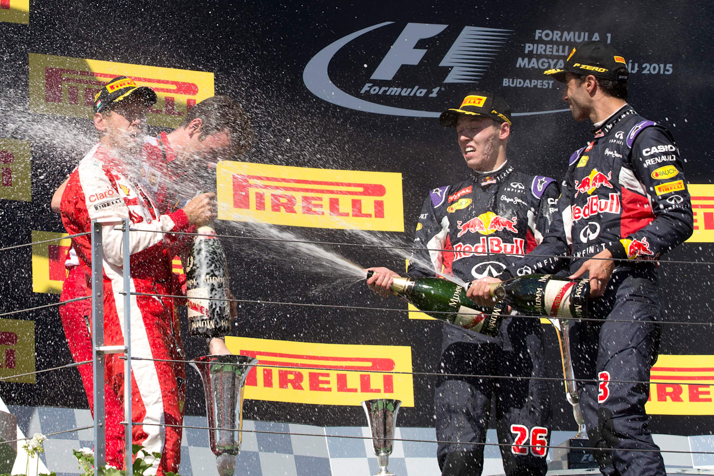 Sebastian Vettel (GER) Ferrari celebrates on the podium with the champagne with James Allison (GBR)