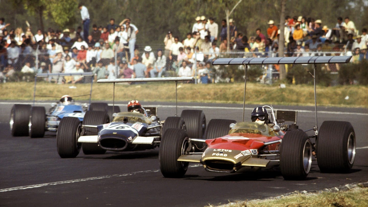 Graham Hill (GBR) Lotus Cosworth 49B, leads pole position man Jo Siffert (SUI) in a similar Rob