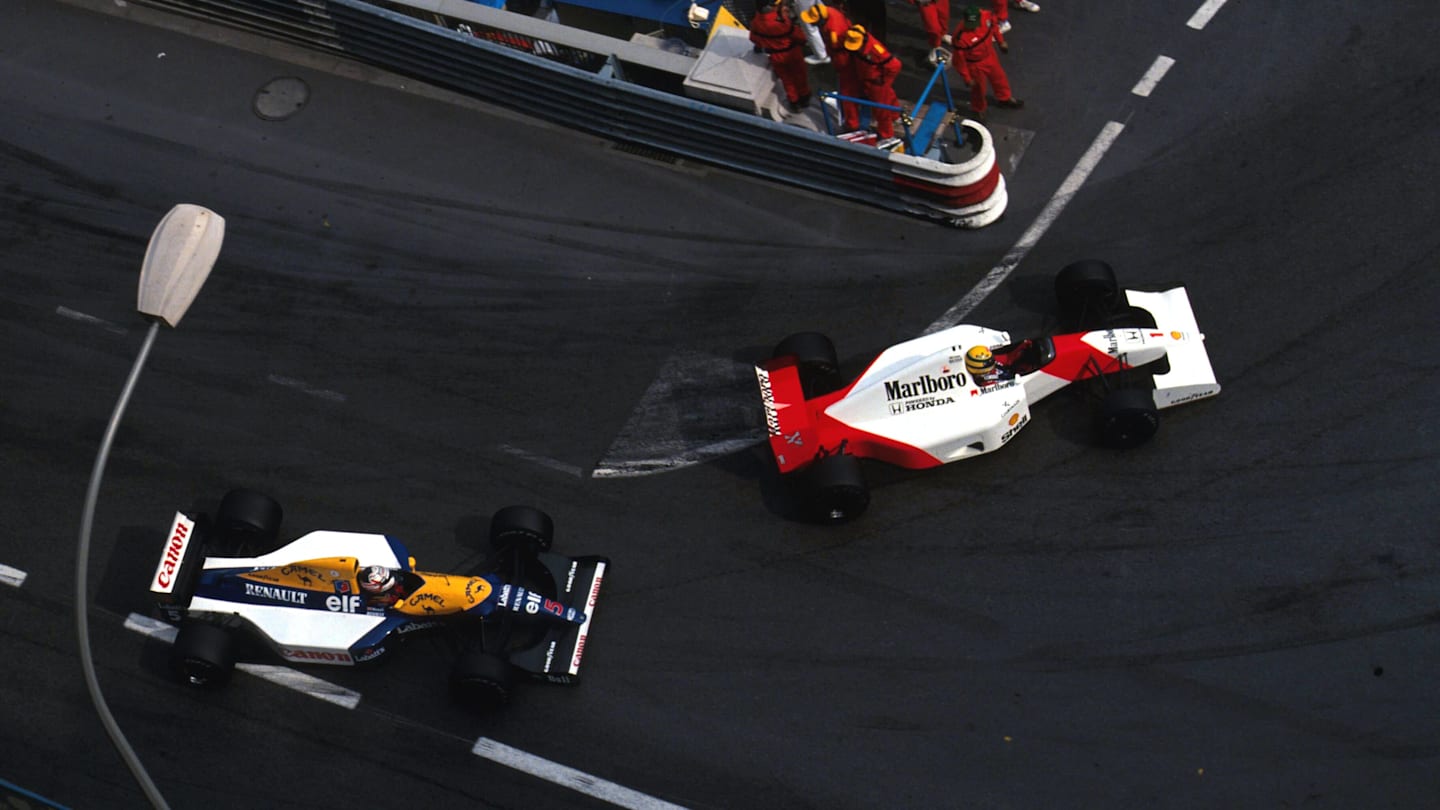 Ayrton Senna (BRA) McLaren MP4/6B leads Nigel Mansell (GBR) Williams FW14B during a very closely