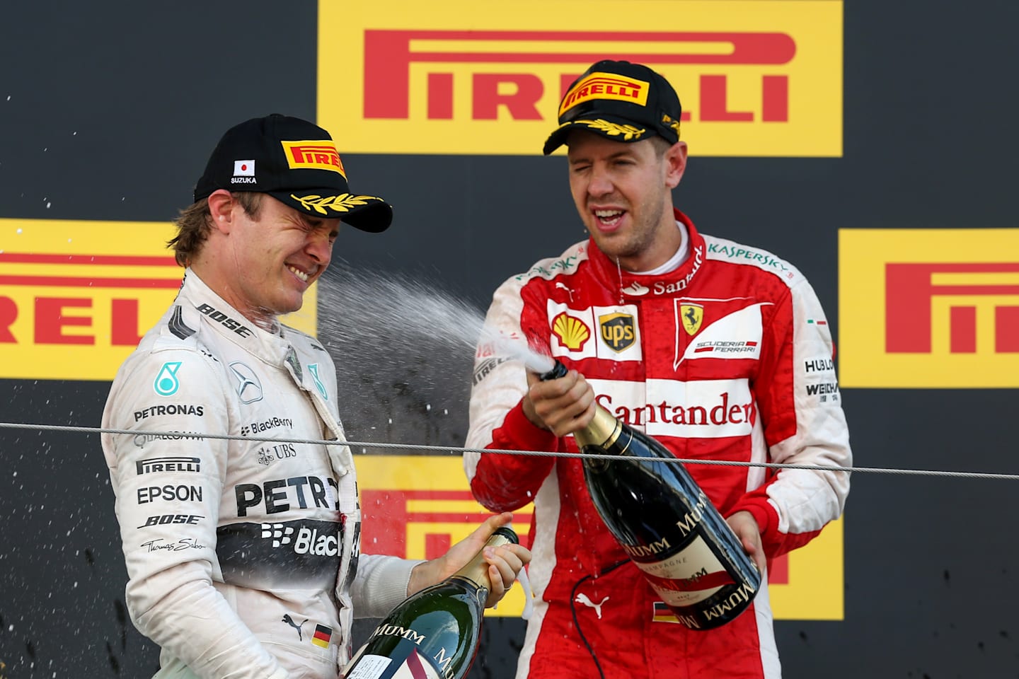 Nico Rosberg (GER) Mercedes AMG F1 and Sebastian Vettel (GER) Ferrari celebrates with the champagne