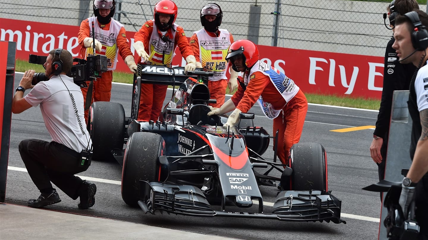 The car of Fernando Alonso (ESP) McLaren MP4-30 is recovered after stopping on track in FP3 at