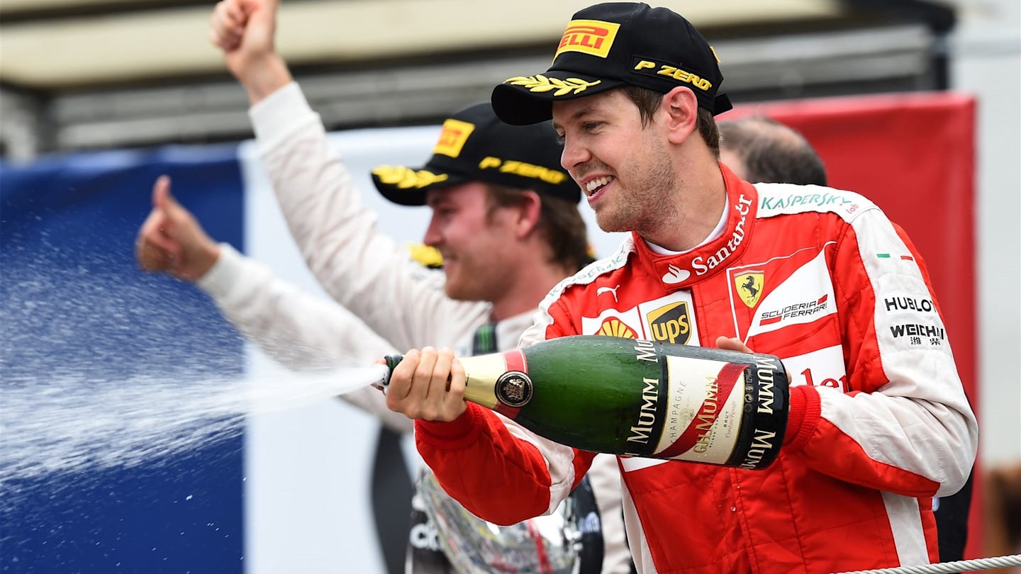 Sebastian Vettel (GER) Ferrari celebrates on the podium with the champagne at Formula One World