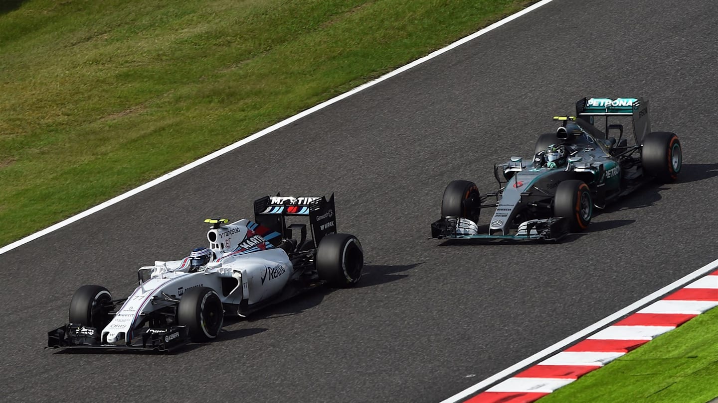 Valtteri Bottas (FIN) Williams FW37 and Nico Rosberg (GER) Mercedes AMG F1 W06 at Formula One World