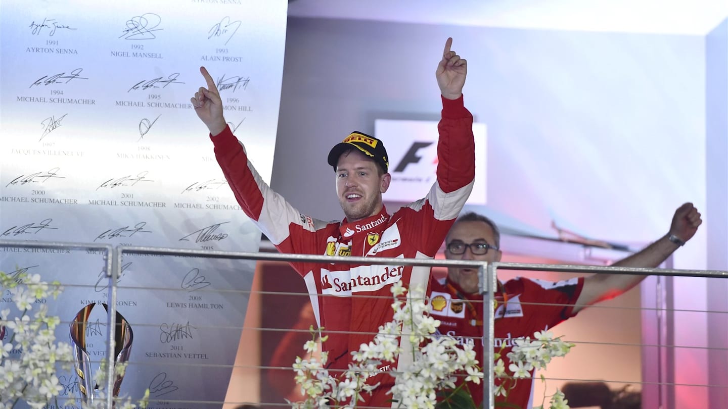 Race winner Sebastian Vettel (GER) Ferrari celebrates on the podium at Formula One World