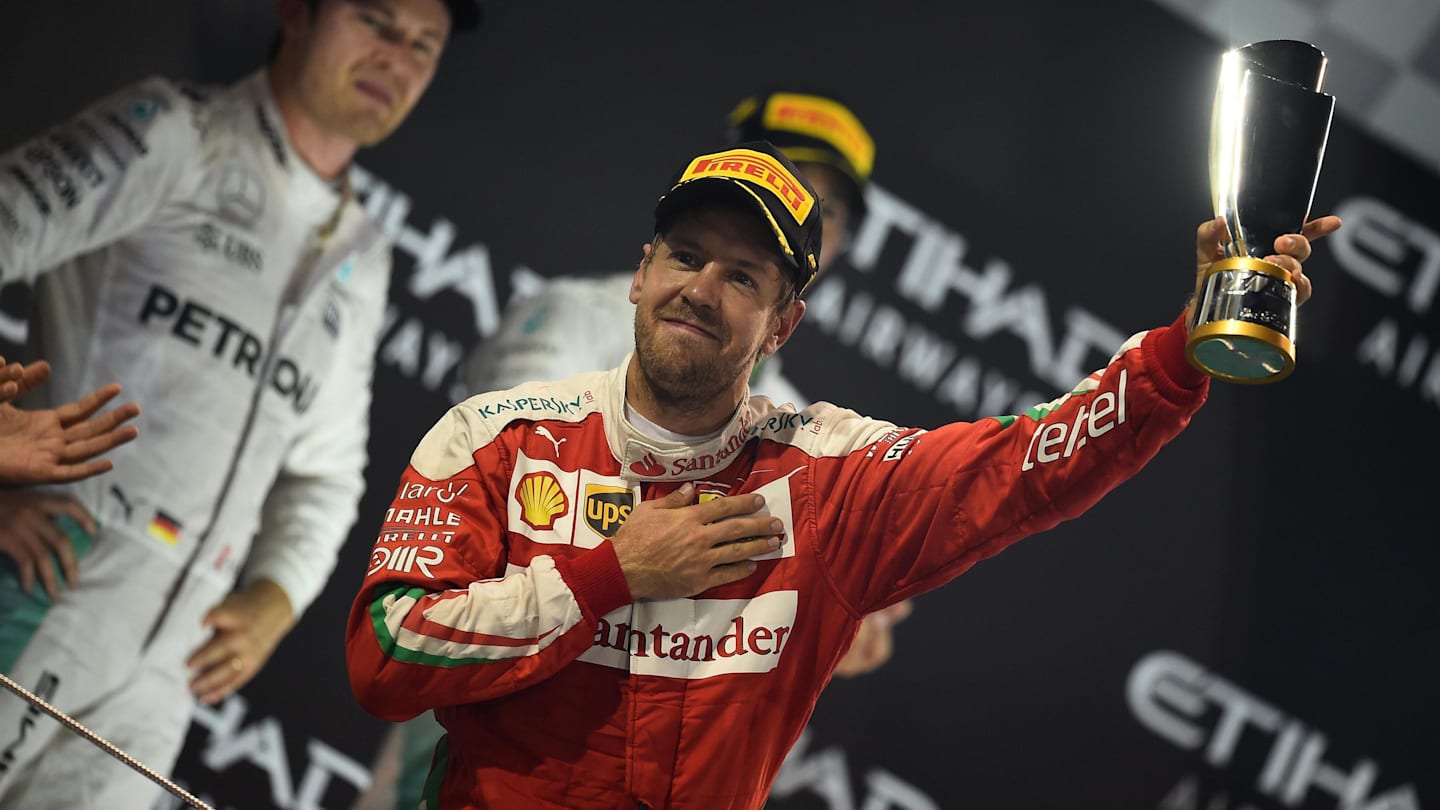 Sebastian Vettel (GER) Ferrari celebrates on the podium with the trophy at Formula One World Championship, Rd21, Abu Dhabi Grand Prix, Race, Yas Marina Circuit, Abu Dhabi, UAE, Sunday 27 November 2016. © Sutton Images