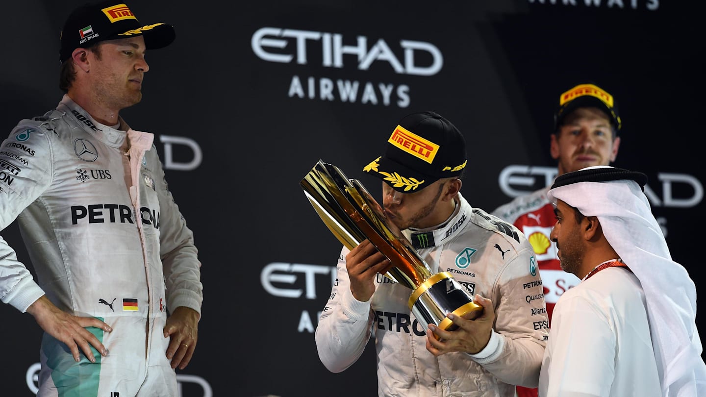 New World Champion Nico Rosberg (GER) Mercedes AMG F1 celebrates on the podium with Lewis Hamilton (GBR) Mercedes AMG F1 and the trophy at Formula One World Championship, Rd21, Abu Dhabi Grand Prix, Race, Yas Marina Circuit, Abu Dhabi, UAE, Sunday 27 November 2016. © Sutton Images