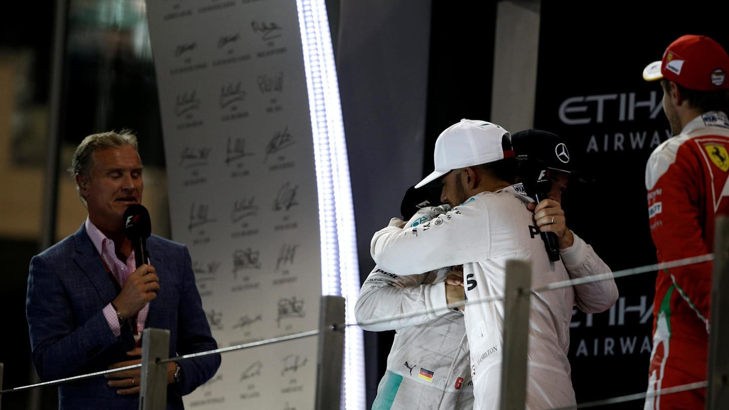 David Coulthard (GBR) Channel Four TV Commentator, World Champion Nico Rosberg (GER) Mercedes AMG F1, race winner Lewis Hamilton (GBR) Mercedes AMG F1 and Sebastian Vettel (GER) Ferrari celebrates on the podium and shake hands at Formula One World Championship, Rd21, Abu Dhabi Grand Prix, Race, Yas Marina Circuit, Abu Dhabi, UAE, Sunday 27 November 2016. © Sutton Images