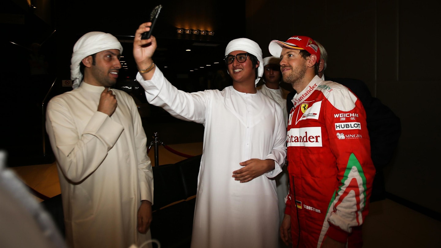 Sebastian Vettel (GER) Ferrari poses for a selfie photo with the fans at Formula One World Championship, Rd21, Abu Dhabi Grand Prix, Race, Yas Marina Circuit, Abu Dhabi, UAE, Sunday 27 November 2016. © Sutton Images