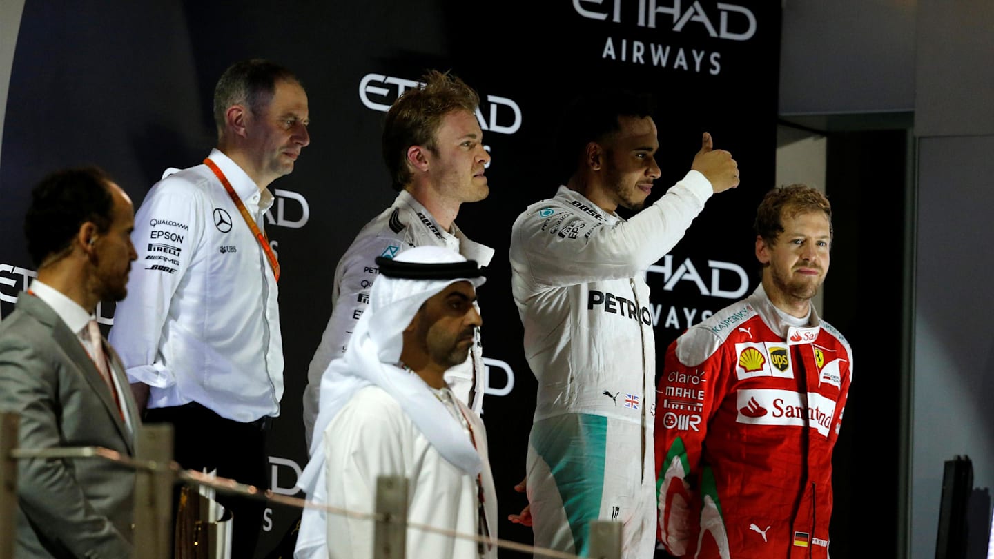 (L to R): Tony Ross (GBR) Mercedes AMG F1 Race Engineer, Nico Rosberg (GER) Mercedes AMG F1, Lewis Hamilton (GBR) Mercedes AMG F1 and Sebastian Vettel (GER) Ferrari on the podium at Formula One World Championship, Rd21, Abu Dhabi Grand Prix, Race, Yas Marina Circuit, Abu Dhabi, UAE, Sunday 27 November 2016. © Sutton Images