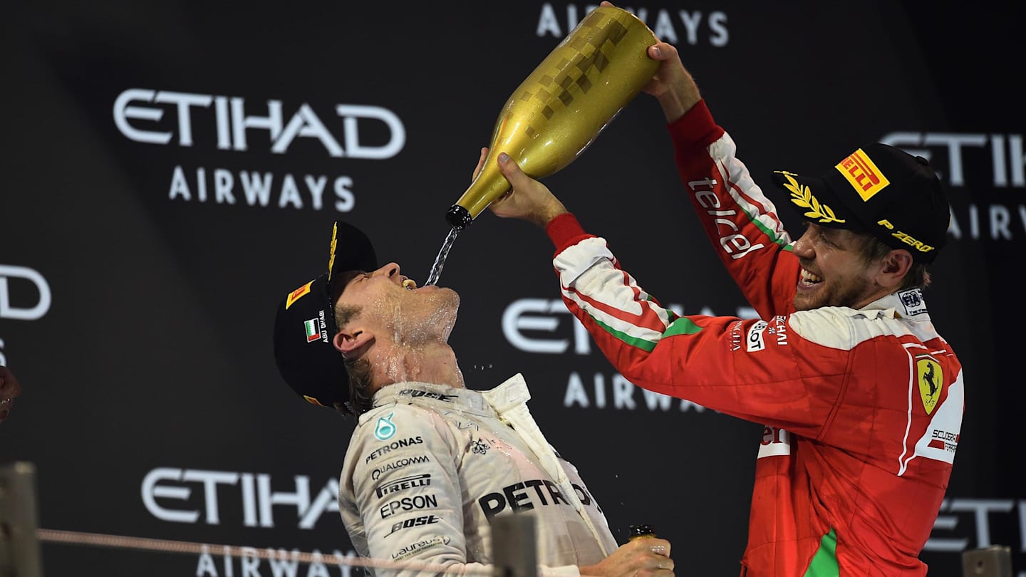 Nico Rosberg (GER) Mercedes AMG F1 and Sebastian Vettel (GER) Ferrari celebrate on the podium at Formula One World Championship, Rd21, Abu Dhabi Grand Prix, Race, Yas Marina Circuit, Abu Dhabi, UAE, Sunday 27 November 2016. © Sutton Images