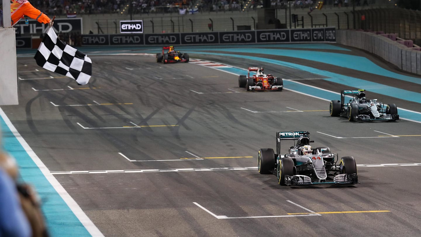 Race winner Lewis Hamilton (GBR) Mercedes-Benz F1 W07 Hybrid takes the chequeredflag followed by Nico Rosberg (GER) Mercedes-Benz F1 W07 Hybrid and Sebastian Vettel (GER) Ferrari SF16-H at Formula One World Championship, Rd21, Abu Dhabi Grand Prix, Race, Yas Marina Circuit, Abu Dhabi, UAE, Sunday 27 November 2016. © Sutton Images