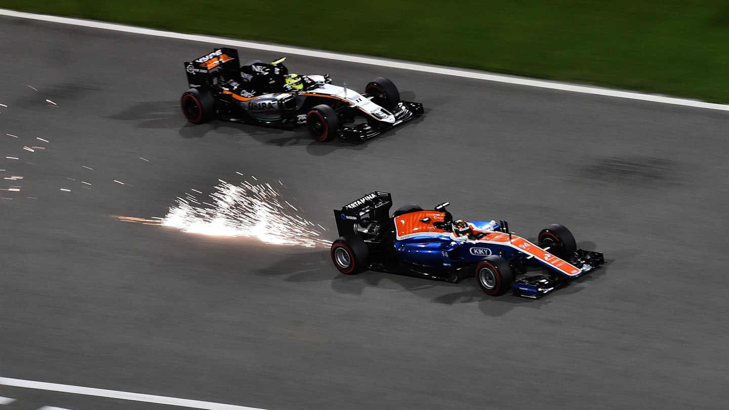 Pascal Wehrlein (GER) Manor Racing MRT05 and Sergio Perez (MEX) Force India VJM09 at Formula One