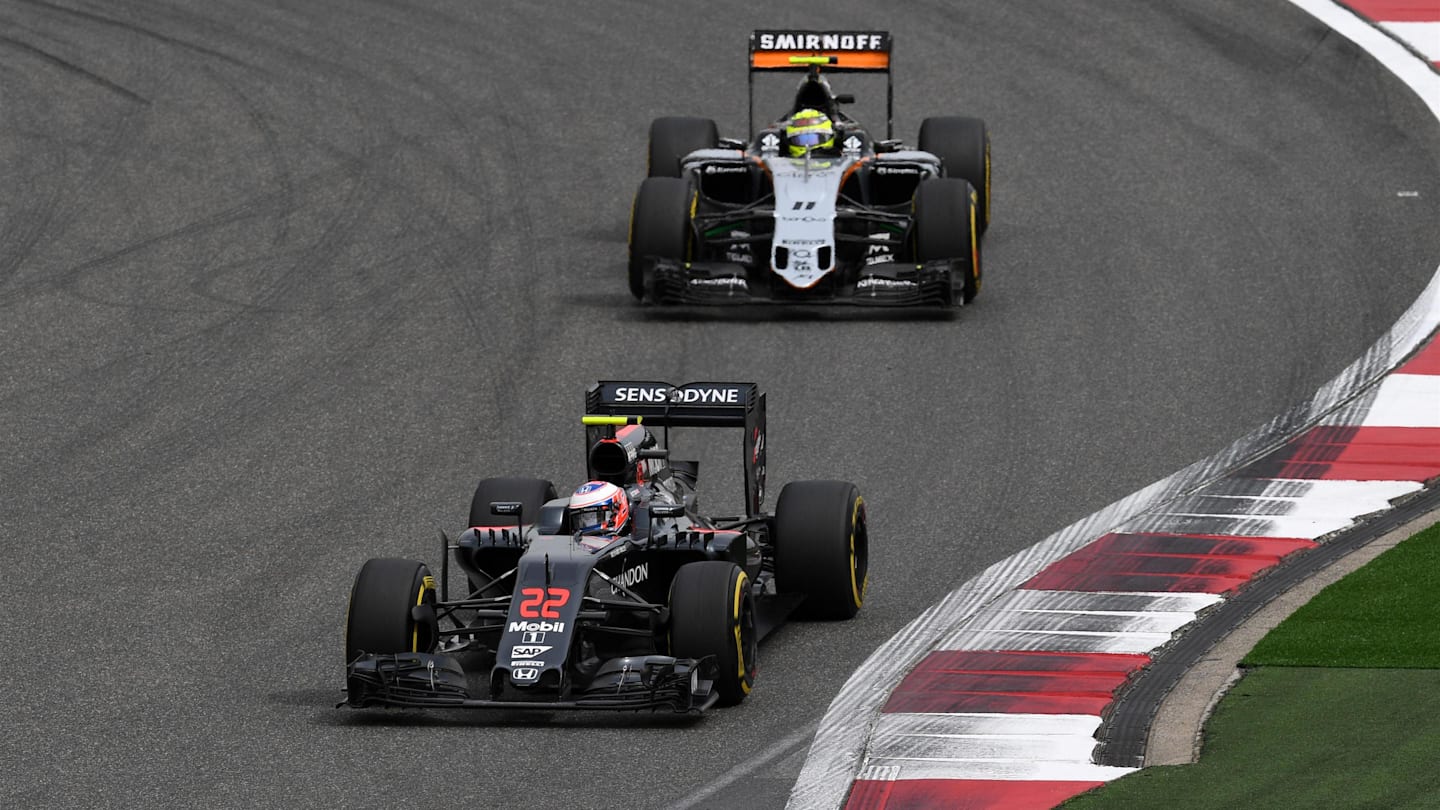 Jenson Button (GBR) McLaren MP4-31 and Sergio Perez (MEX) Force India VJM09 at Formula One World