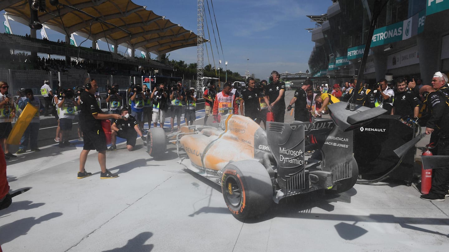 The burning car of Kevin Magnussen (DEN) Renault Sport F1 Team RS16 in pit lane during FP1 at Formula One World Championship, Rd16, Malaysian Grand Prix, Practice, Sepang, Malaysia, Friday 30 September 2016. © Sutton Images