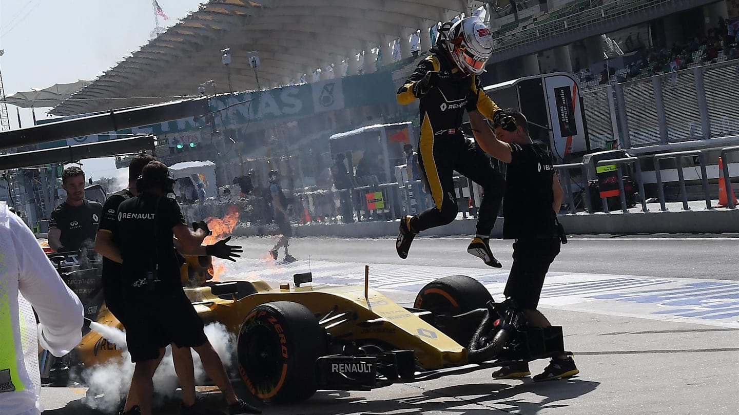 Kevin Magnussen (DEN) Renault Sport F1 Team RS16 leaps from his on fire car in FP1 at Formula One World Championship, Rd16, Malaysian Grand Prix, Practice, Sepang, Malaysia, Friday 30 September 2016. © Sutton Images