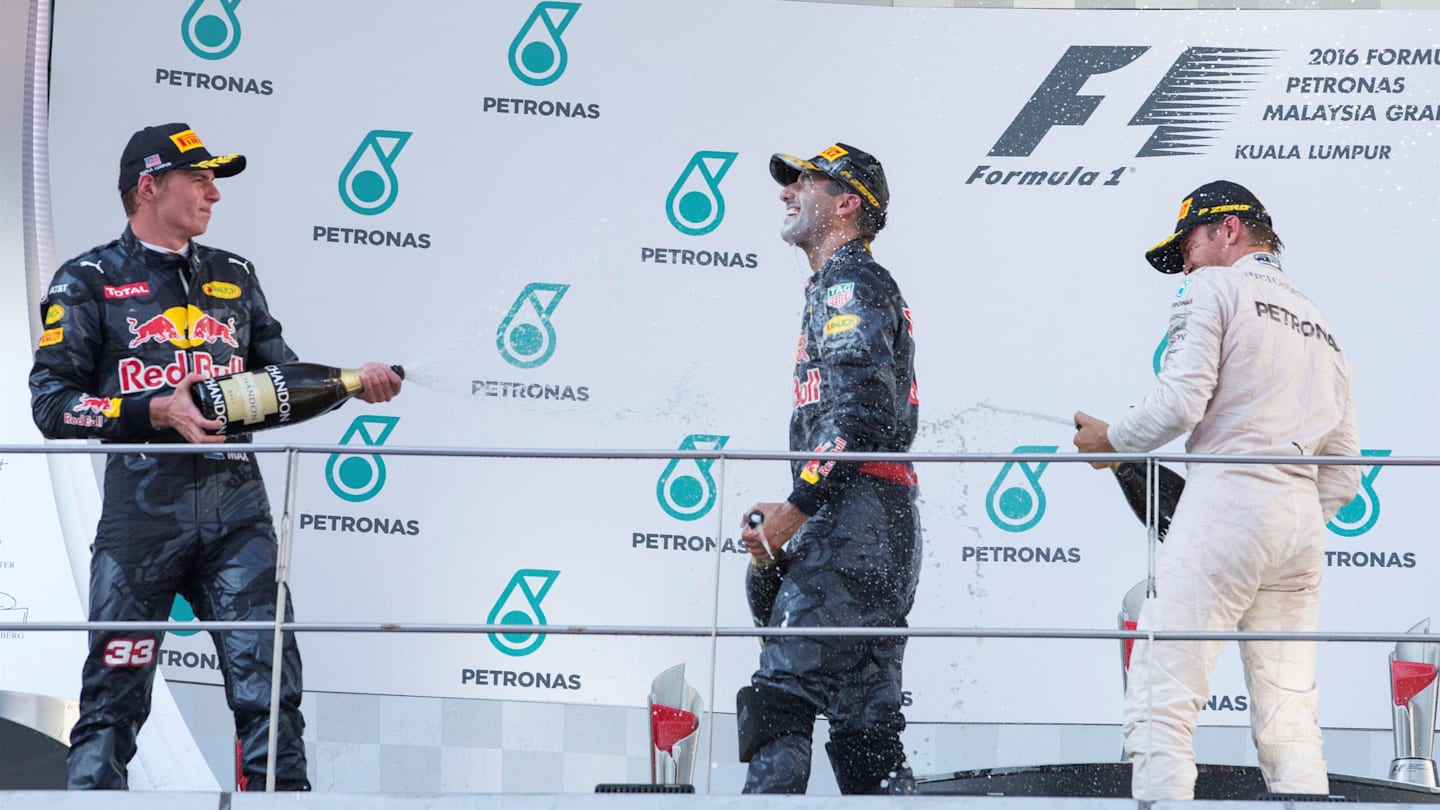 Max Verstappen (NED) Red Bull Racing, race winner Daniel Ricciardo (AUS) Red Bull Racing and Nico Rosberg (GER) Mercedes AMG F1 celebrate on the podium with the champagne at Formula One World Championship, Rd16, Malaysian Grand Prix, Race,  Sepang, Malaysia, Sunday 2 October 2016. © Sutton Images