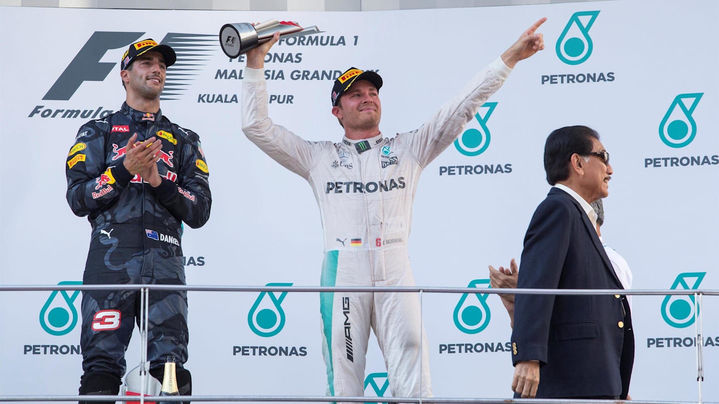 Race winner Daniel Ricciardo (AUS) Red Bull Racing and Nico Rosberg (GER) Mercedes AMG F1 celebrate opn the podium with the trophy at Formula One World Championship, Rd16, Malaysian Grand Prix, Race,  Sepang, Malaysia, Sunday 2 October 2016. © Sutton Images