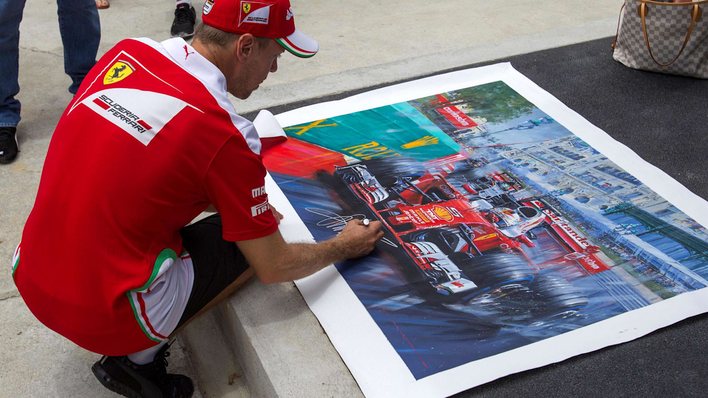 Sebastian Vettel (GER) Ferrari signs a painting at Formula One World Championship, Rd16, Malaysian Grand Prix, Preparations, Sepang, Malaysia, Thursday 29 September 2016. © Sutton Images