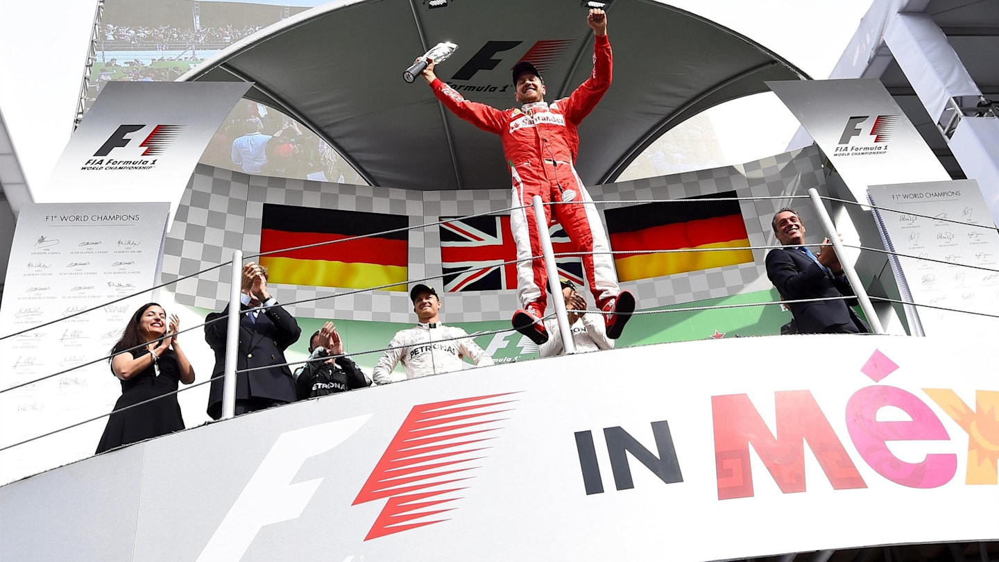 Sebastian Vettel (GER) Ferrari celebrates on the podium with the trophy at Formula One World