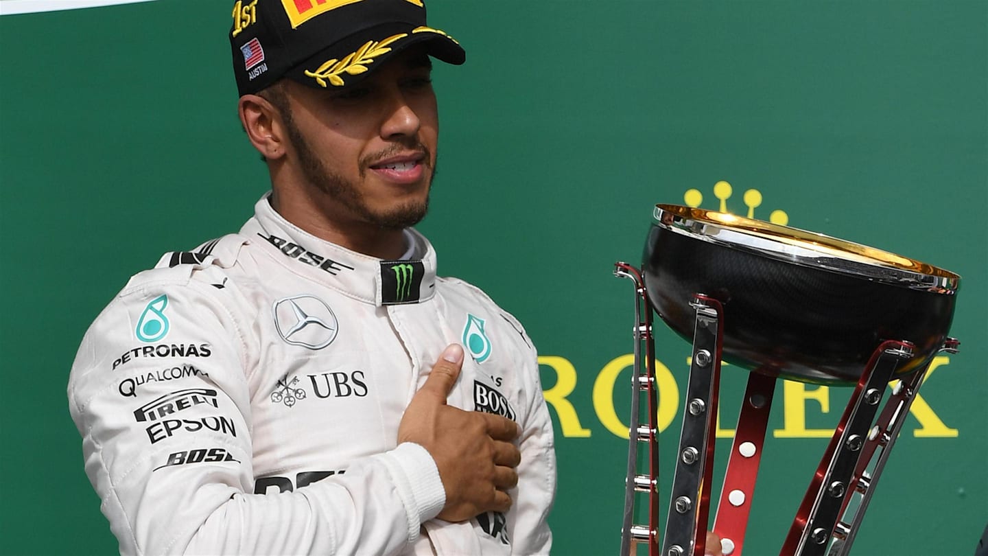 Race winner Lewis Hamilton (GBR) Mercedes AMG F1 on the podium with the trophy at Formula One World