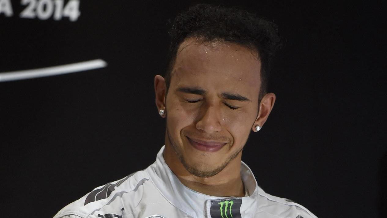 Lewis Hamilton (GBR) Mercedes AMG F1 celebrates on the podium. Formula One World Championship, Rd19, Abu Dhabi Grand Prix, Race, Yas Marina Circuit, Abu Dhabi, UAE, Sunday, 23 November 2014