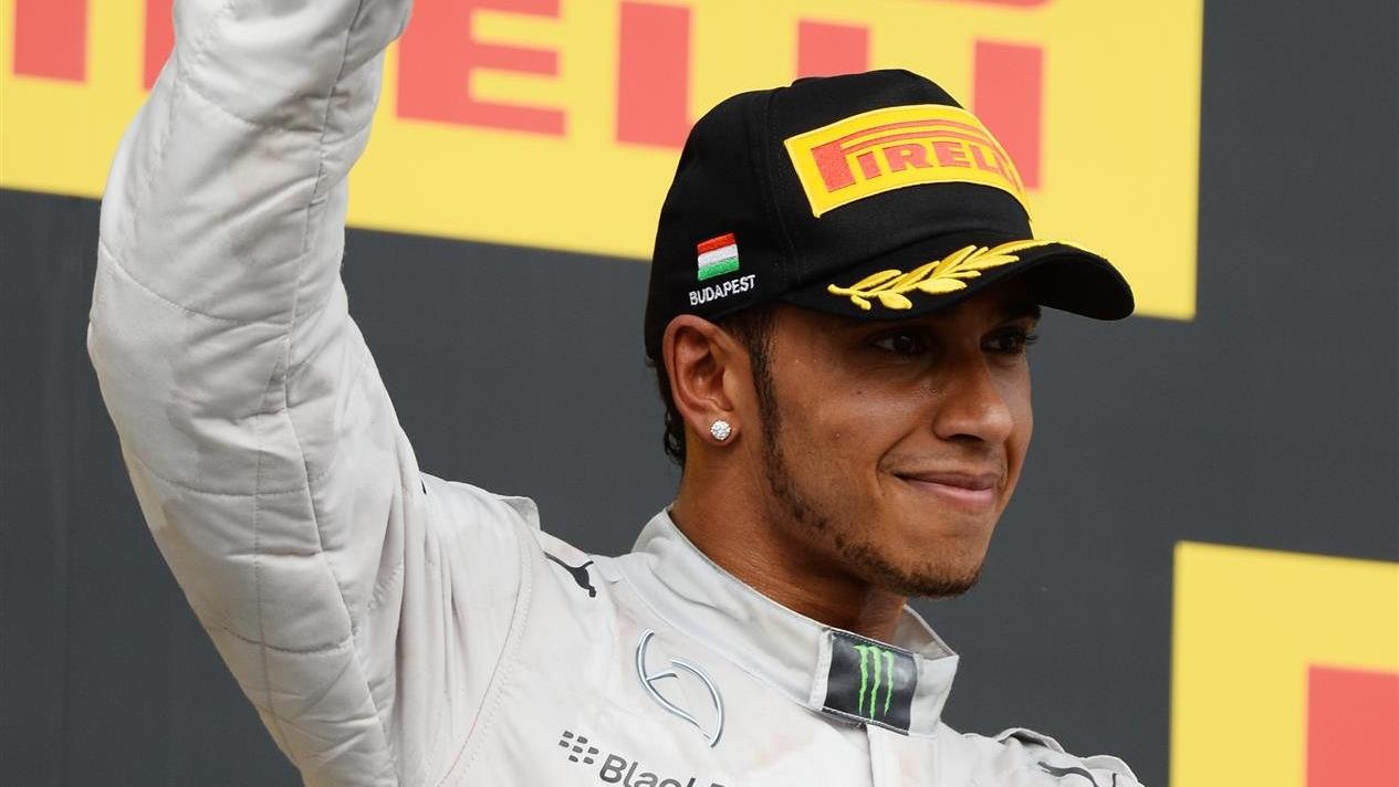 Lewis Hamilton (GBR) Mercedes AMG F1 celebrates on the podium. Formula One World Championship, Rd11, Hungarian Grand Prix, Race Day, Hungaroring, Hungary. Sunday, 27 July 2014