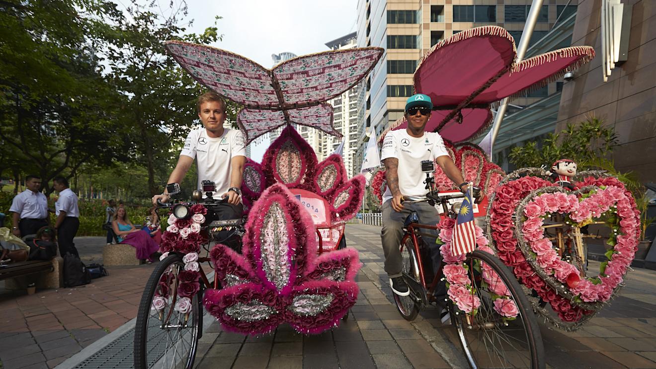 Mercedes' Nico Rosberg and Lewis Hamilton ride trishaws, Kuala Lumpur, Malaysia, March 2014 © Daimler AG