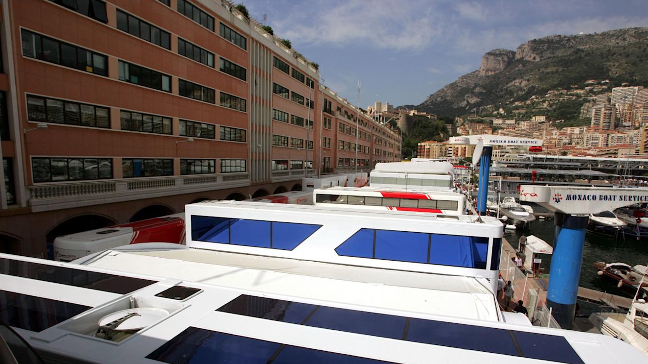 The teams' motorhomes are squeezed between buildings and the harbour in the paddock