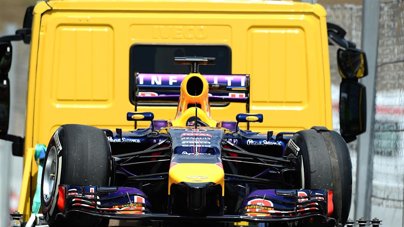 The stricken car of Sebastian Vettel (GER) Red Bull Racing RB10 is brought back to the pitlane after he stopped early in Q3. Formula One World Championship, Rd5, Spanish Grand Prix, Qualifying, Barcelona, Spain, Saturday, 10 May 2014