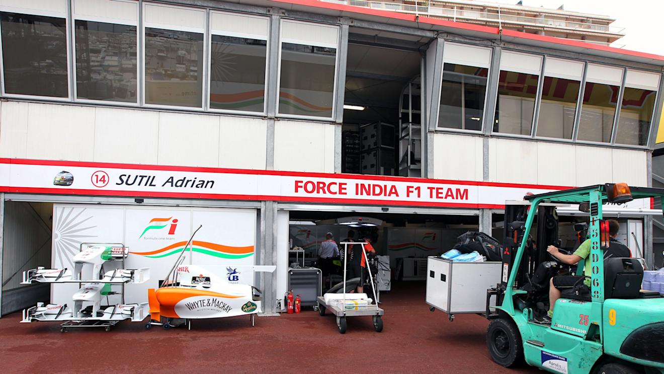 Freight is loaded into the Force India garage