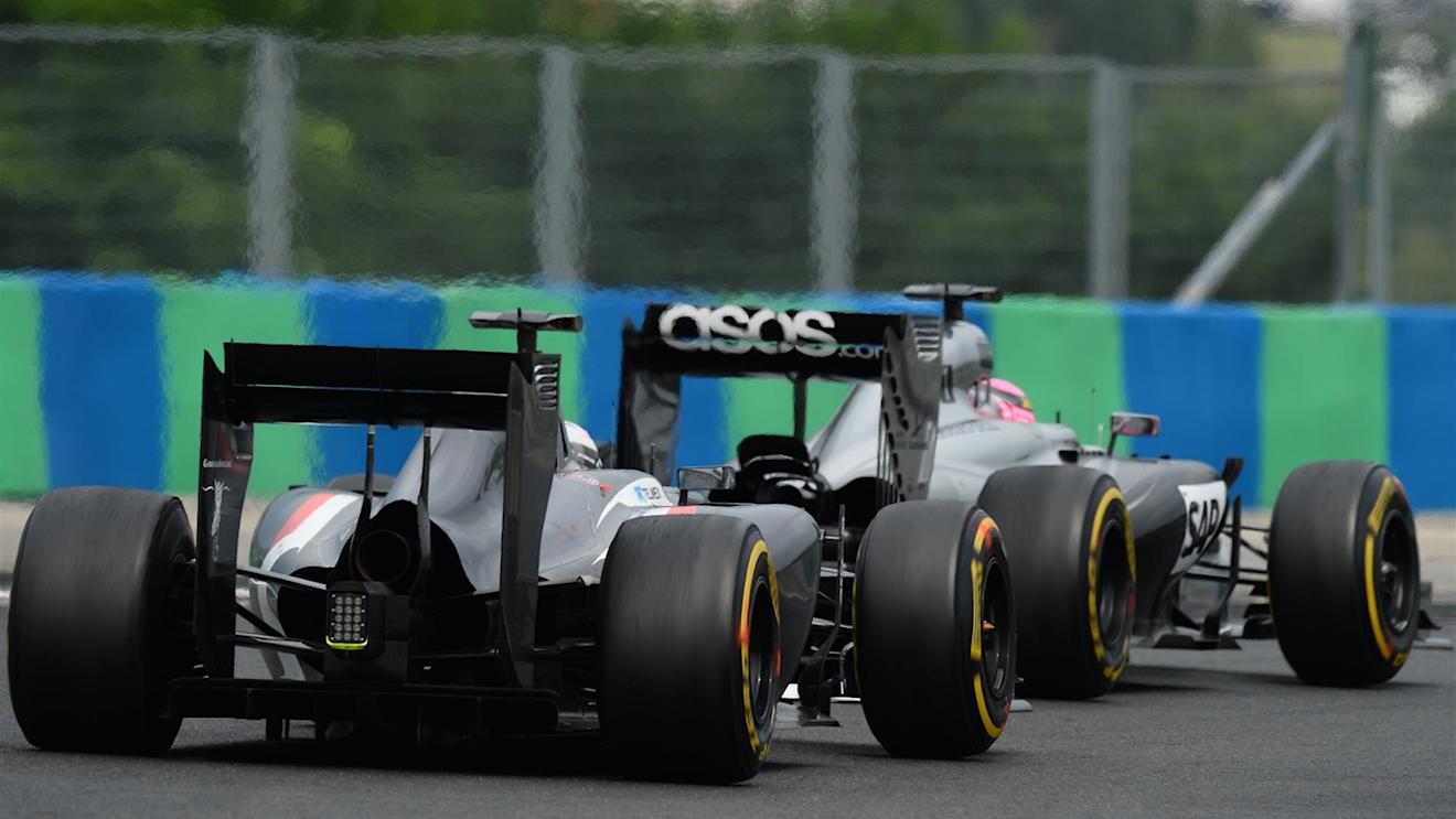 Jenson Button (GBR) McLaren MP4-29 and Adrian Sutil (GER) Sauber C33. Formula One World Championship, Rd11, Hungarian Grand Prix, Race Day, Hungaroring, Hungary. Sunday, 27 July 2014 © Sutton Images. No reproduction without permission
