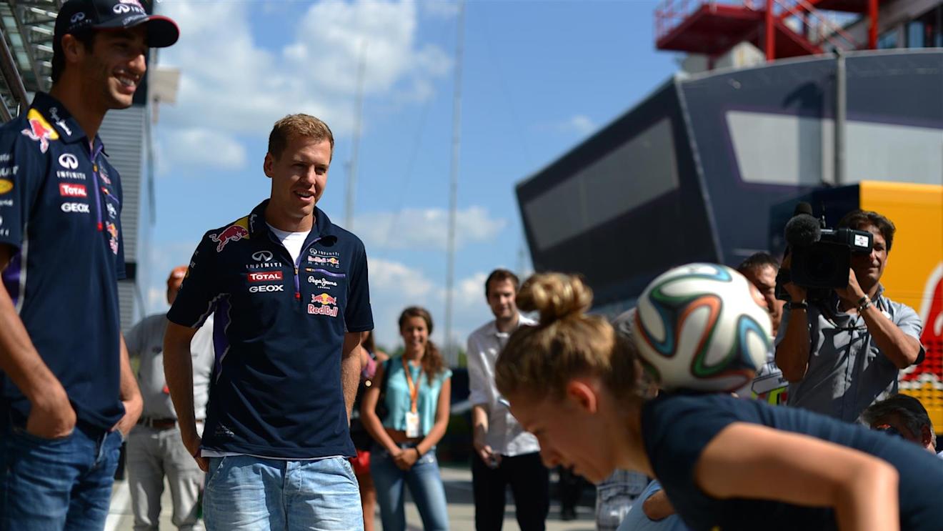 Daniel Ricciardo (AUS) Red Bull Racing and Sebastian Vettel (GER) Red Bull Racing watch soccer skills. Formula One World Championship, Rd11, Hungarian Grand Prix, Preparations, Hungaroring, Hungary. Thursday, 24 July 2014 © Sutton Images. No reproduction without permission