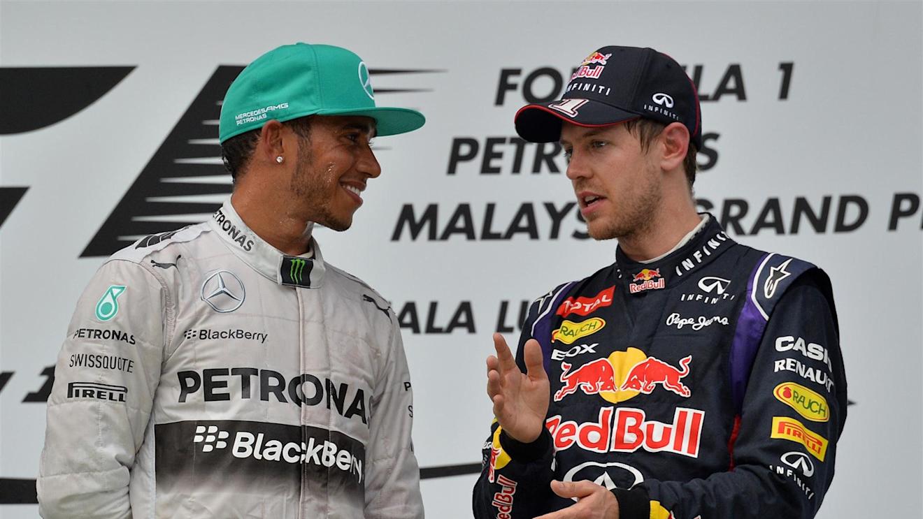 Race winner Lewis Hamilton (GBR) Mercedes AMG F1 and Sebastian Vettel (GER) Red Bull Racing on the podium. Formula One World Championship, Rd2, Malaysian Grand Prix, Race, Sepang, Malaysia, Sunday, 30 March 2014 © Sutton Images. No reproduction without permission