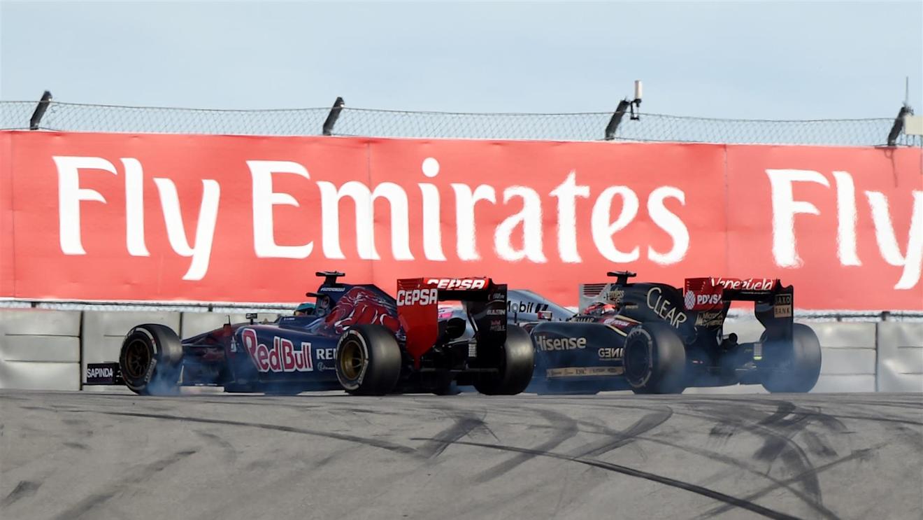 Jean-Eric Vergne (FRA) Scuderia Toro Rosso STR9 overtakes Romain Grosjean (FRA) Lotus E22. Formula One World Championship, Rd17, United States Grand Prix, Race, Austin, Texas, USA, Sunday, 2 November 2014