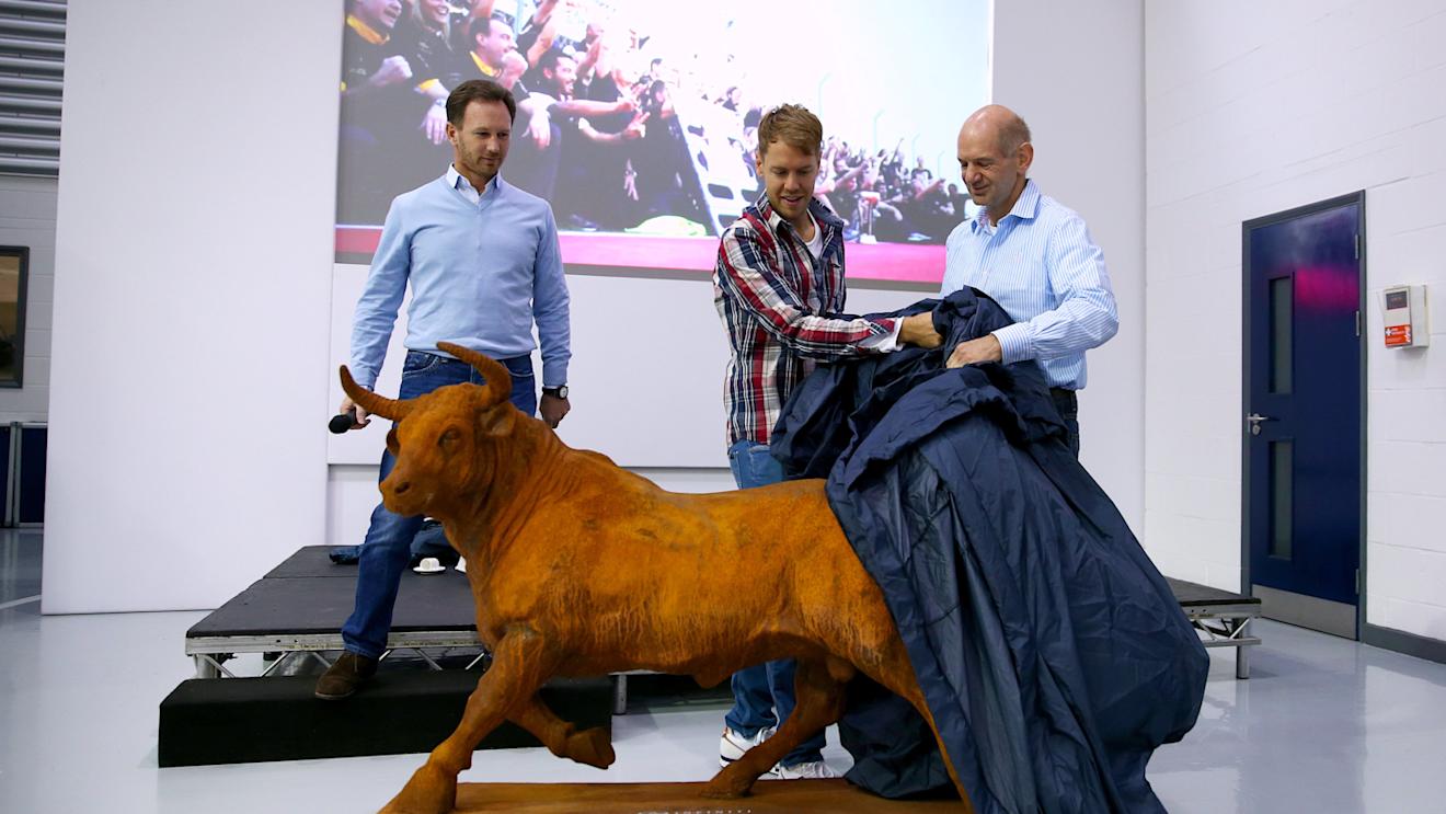 Departing Sebastian Vettel is presented with a bull statue by Red Bull's Christian Horner and Adrian Newey, Milton Keynes, December 2 2014. © Red Bull