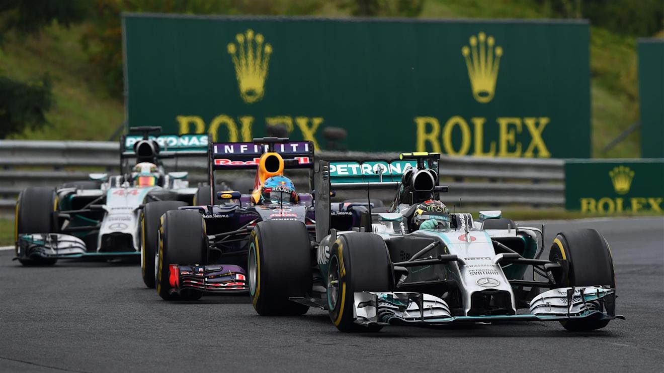 Nico Rosberg (GER) Mercedes AMG F1 W05 leads Sebastian Vettel (GER) Red Bull Racing RB10 and Lewis Hamilton (GBR) Mercedes AMG F1 W05. Formula One World Championship, Rd11, Hungarian Grand Prix, Race Day, Hungaroring, Hungary. Sunday, 27 July 2014. © Sutton Images