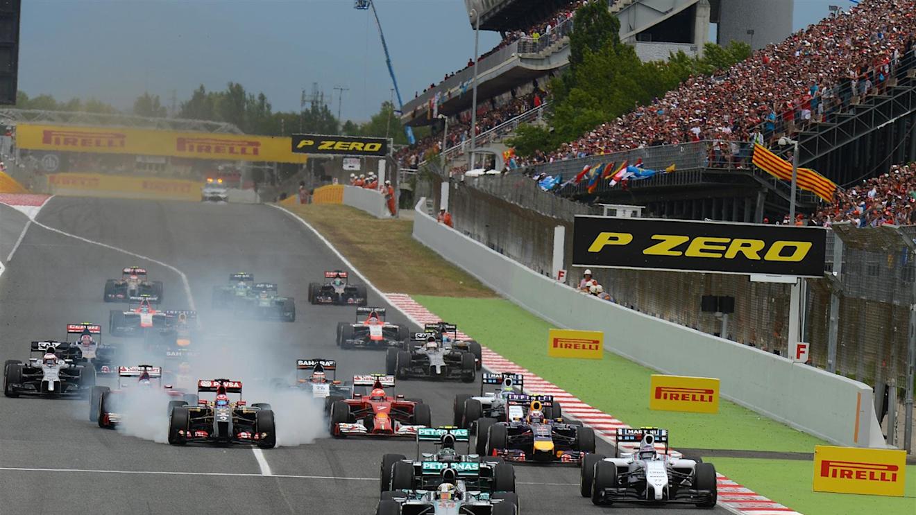 Lewis Hamilton (GBR) Mercedes AMG F1 W05 leads at the start of the race as Romain Grosjean (FRA) Lotus E22 locks up his brakes. Formula One World Championship, Rd5, Spanish Grand Prix, Race, Barcelona, Spain, Sunday, 11 May 2014. © Sutton Images