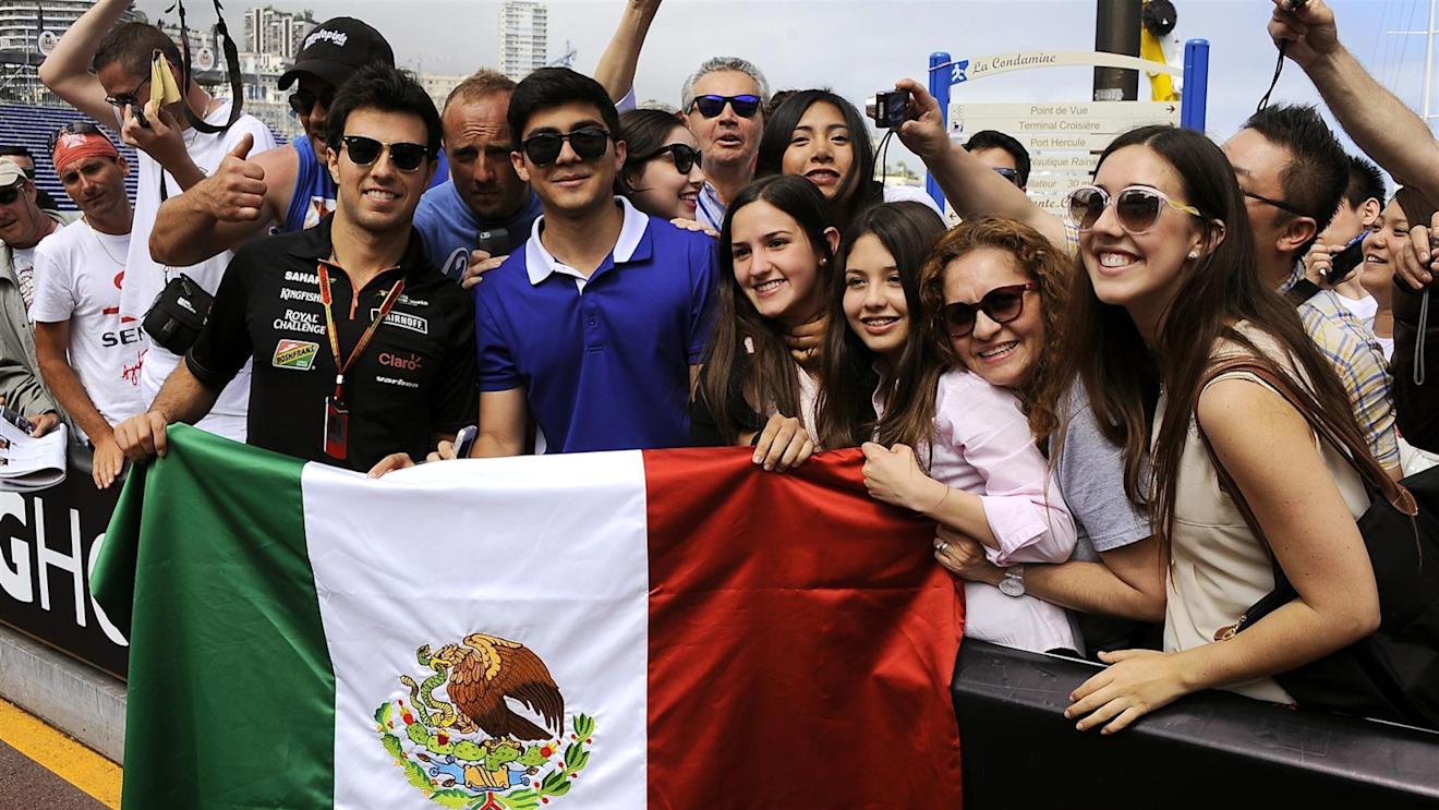 Sergio Perez (MEX) Force India F1 Team holds up a Mexican flag with fans. Formula One World Championship, Rd6, Monaco Grand Prix, Monte-Carlo, Monaco, Friday, 23 May 2014