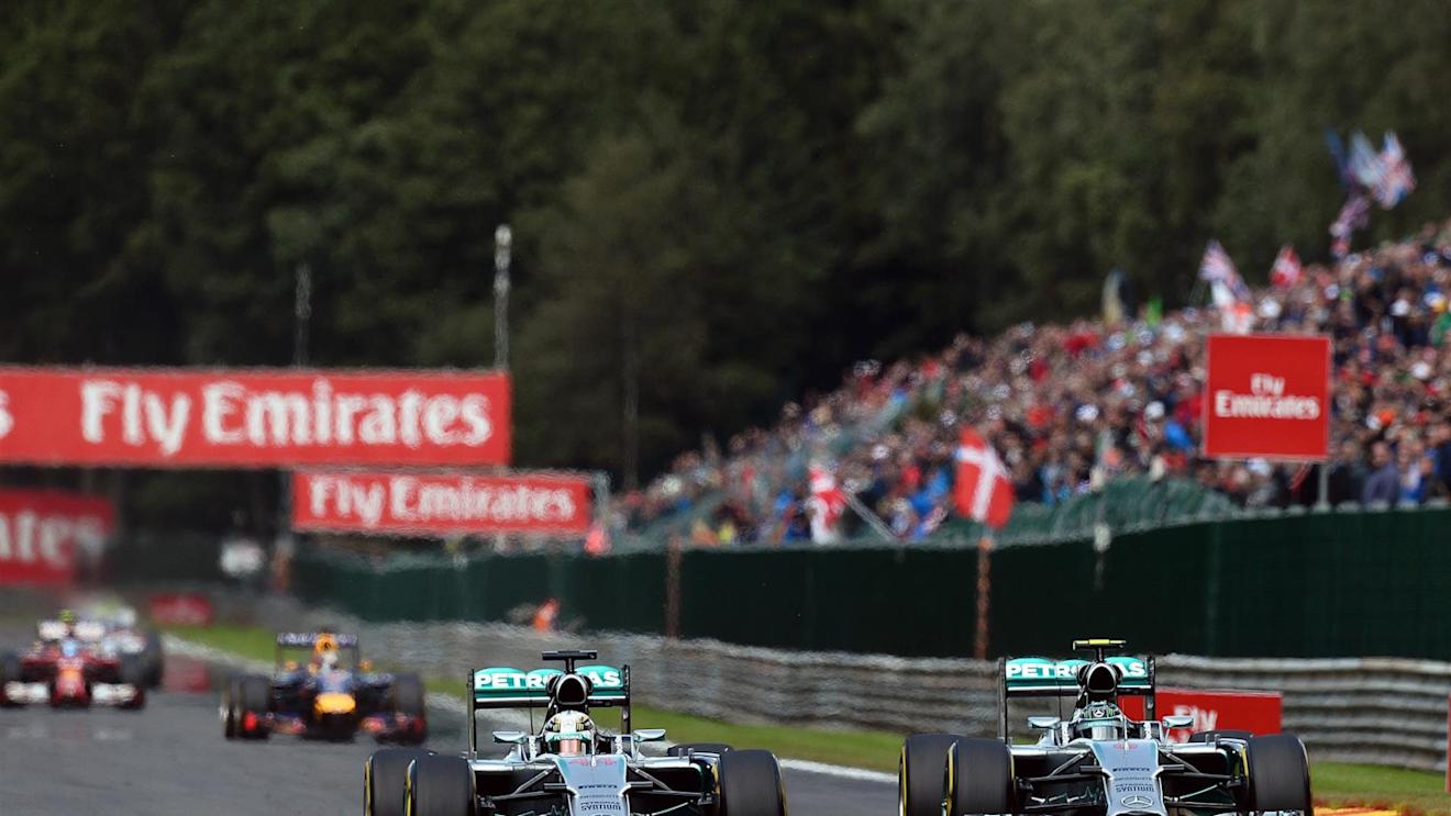 (L to R): Lewis Hamilton (GBR) Mercedes AMG F1 W05 and Nico Rosberg (GER) Mercedes AMG F1 W05 battle at Les Coombes on lap 2. Rosberg damaged his front wing and punctured the left rear wheel of Hamilton's car in the process. Formula One World Championship, Rd12, Belgian Grand Prix, Race Day, Spa-Francorchamps, Belgium, Sunday, 24 August 2014. © Sutton Images