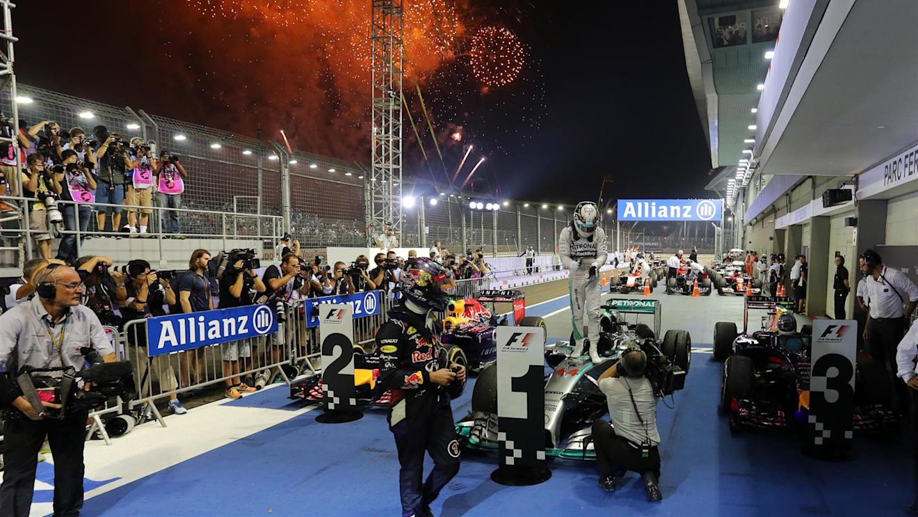 Sebastian Vettel (GER) Red Bull Racing and Lewis Hamilton (GBR) Mercedes AMG F1 W05 in parc ferme. Formula One World Championship, Rd14, Singapore Grand Prix, Marina Bay Street Circuit, Singapore, Race Day, Sunday, 21 September 2014