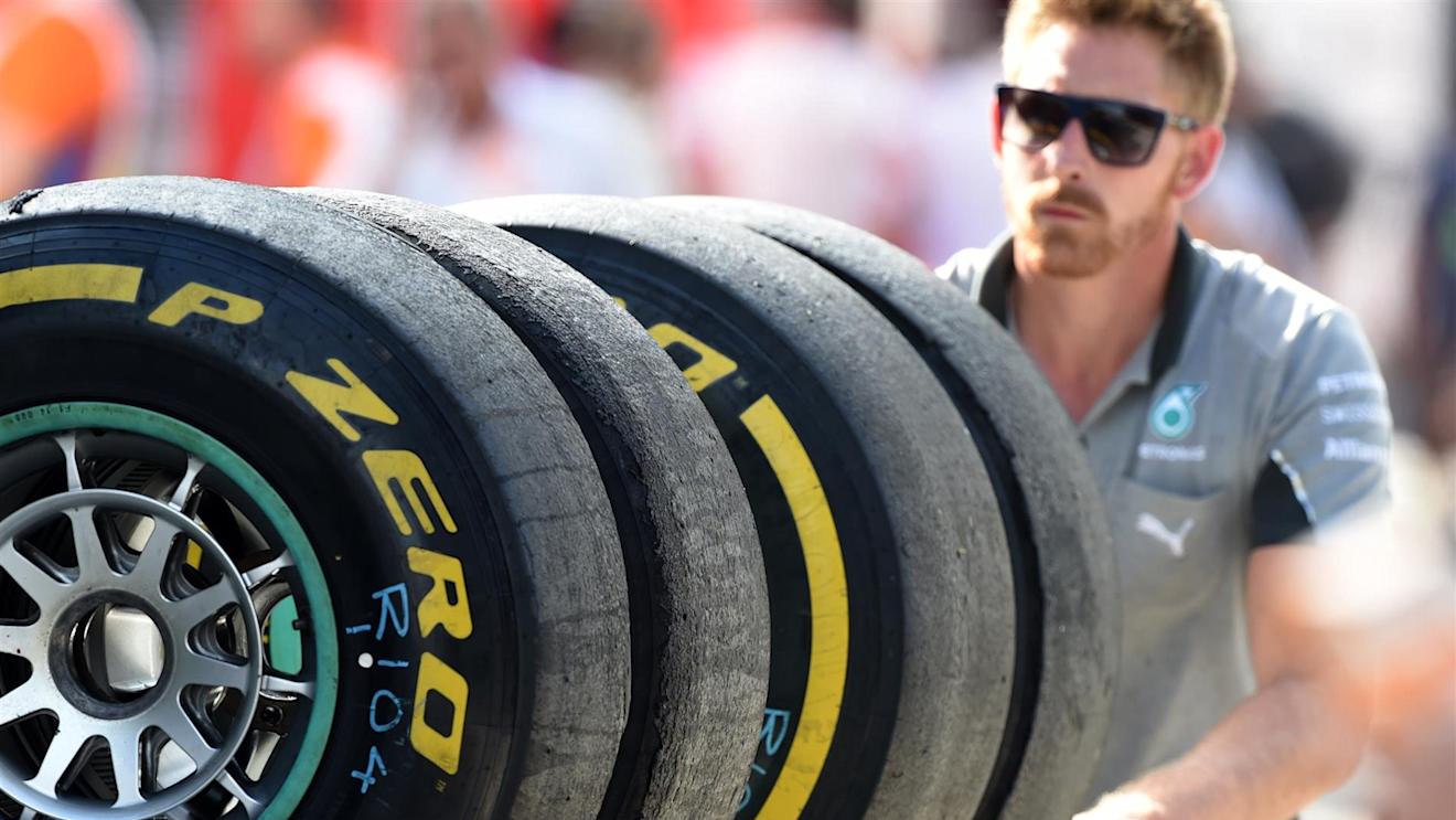 Mercedes AMG F1 mechanic with Pirelli tyres. Formula One World Championship, Rd11, Hungarian Grand Prix, Practice, Hungaroring, Hungary. Friday, 25 July 2014