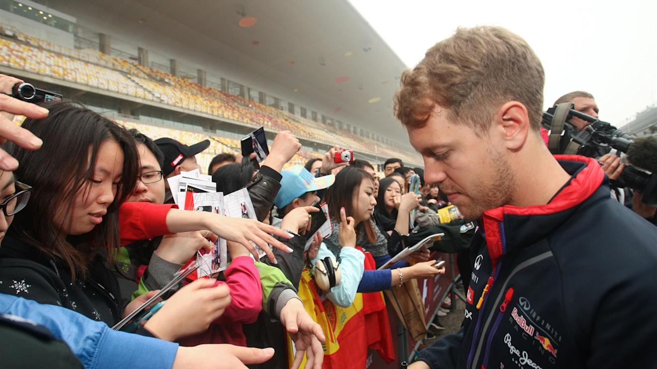 Sebastian Vettel (GER) Red Bull Racing signs autographs for the fans. Formula One World Championship, Rd4, Chinese Grand Prix, Preparations, Shanghai, China, Thursday, 17 April 2014