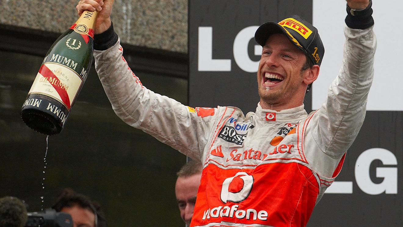 Race winner Jenson Button celebrates his victory on the podium